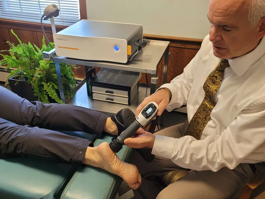 Dr. Diener performing shockwave therapy on a patient's heel
