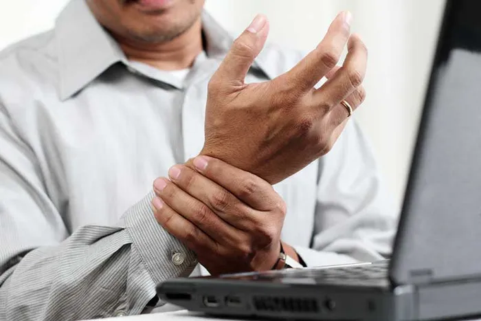 Wrist pain at a laptop — Carpal Tunnel Syndrome care in Weymouth, MA